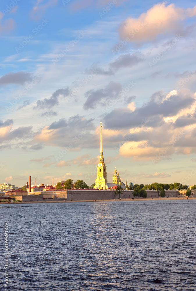 Peter and Paul fortress on the Neva. The spire of the Cathedral of the XVIII century against a cloudy sky, waves on the river, stone bastions Peter and Paul fortress on the Neva. The spire of the Cathedral of the XVIII century against a cloudy sky, waves on the river, stone bastions