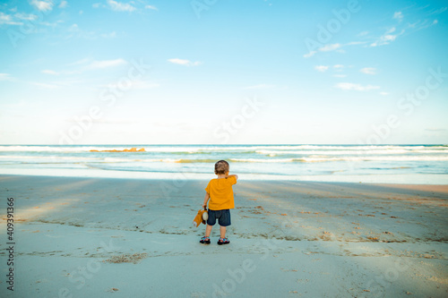 Boy pointing to the sea