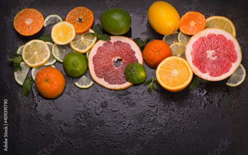Citrus background. Fresh citrus fruits - Lemons, oranges, limes, grapefruits on wooden background. © Irina Ukrainets