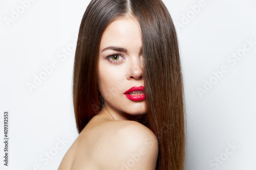 Woman with long hairstyle on the face lipstick 