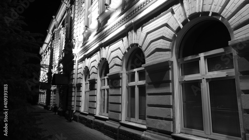  The facade of the building at night under the light of street lamps