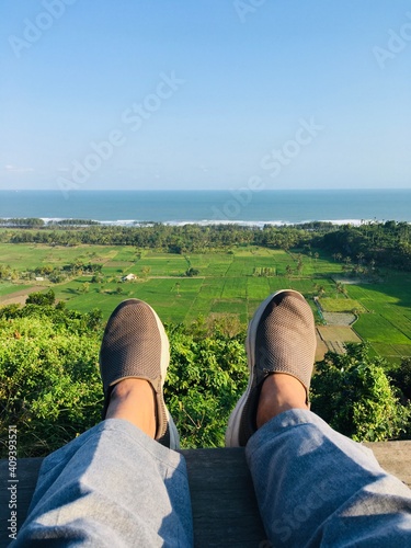 Feet in Photo Frame with Sea View Far ahead
