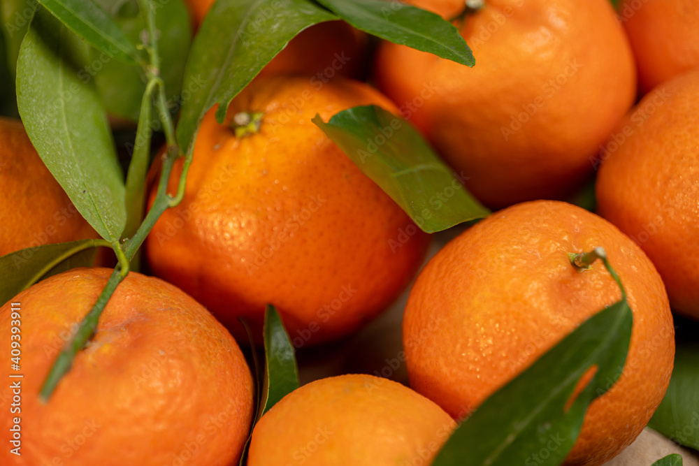 tangerines with leaves on a texture bag tangerines with leaves on a texture bag