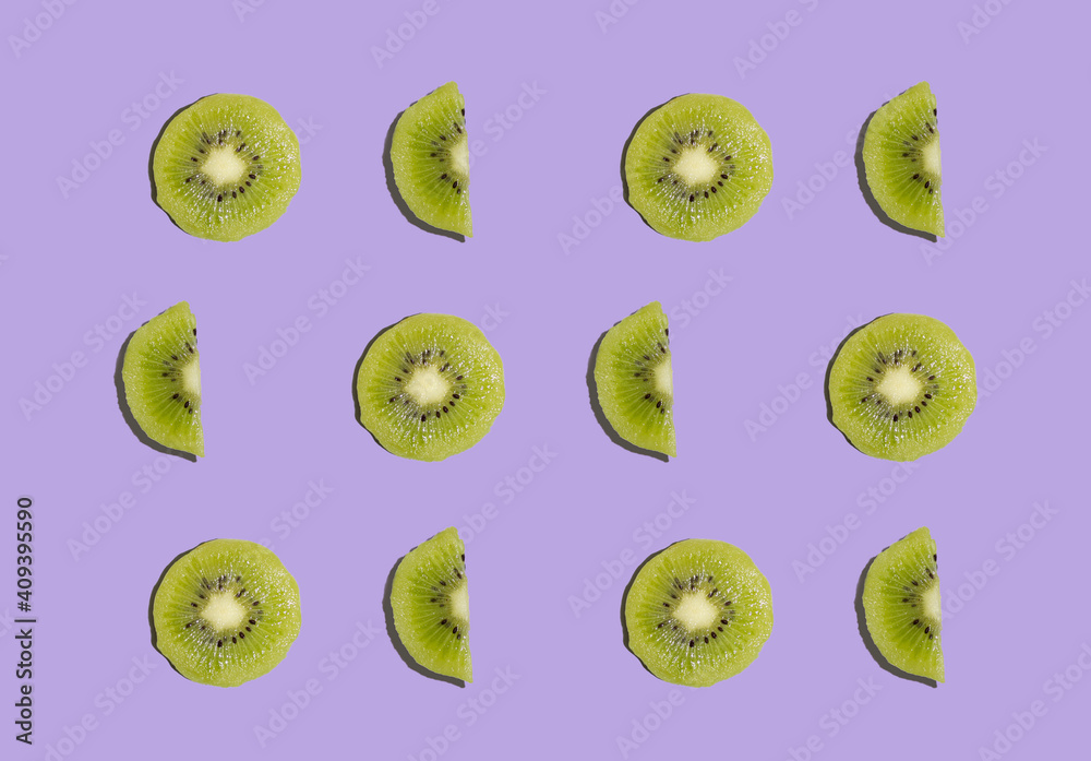 Fototapeta premium Kiwi isolated on purple background. Half of kiwi. Kiwi pattern. Food photography.