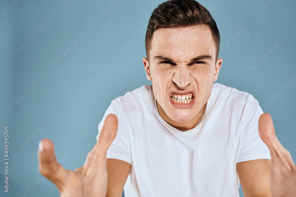 emotional displeased man cropped view white t-shirt blue background emotional displeased man cropped view white t-shirt blue background