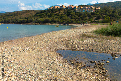 Beautiful natural beach called Plage D Orzo with   a holiday resort in the background  near St. Florent. Corsica  France. Tourism and vacations concept.