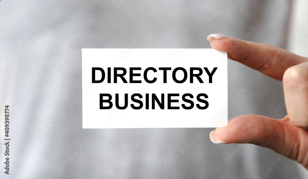 The girl holds a business card with the text DIRECTORY BUSINESS.