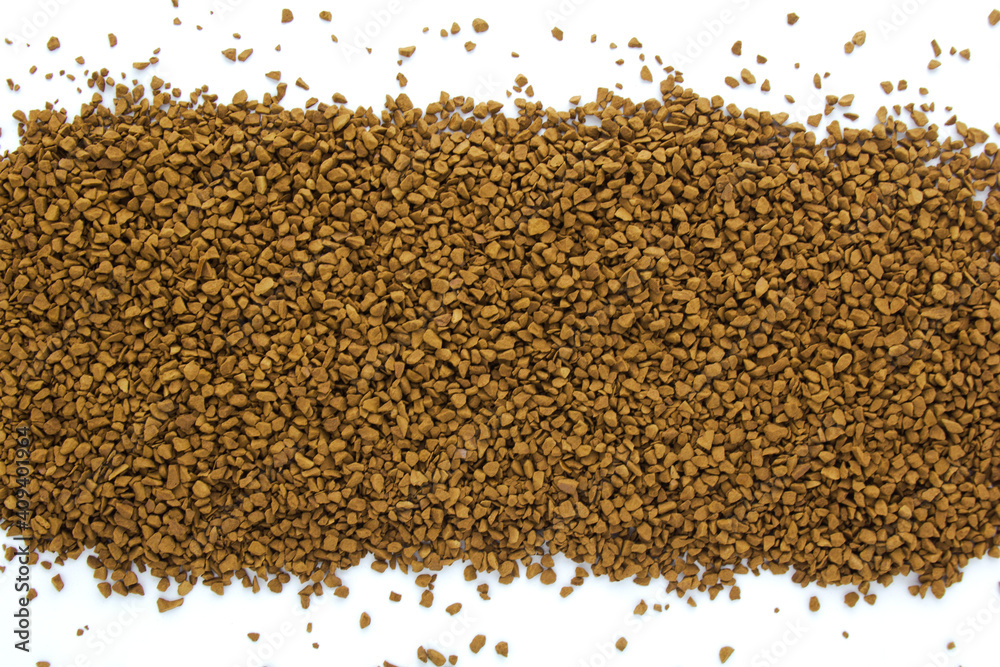 Instant granulated coffee scattered on white background. Top view. Copy space for text.
