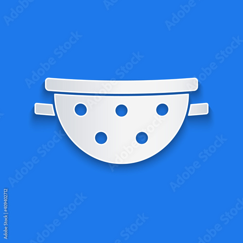 Paper cut Kitchen colander icon isolated on blue background. Cooking utensil. Cutlery sign. Paper art style. Vector.