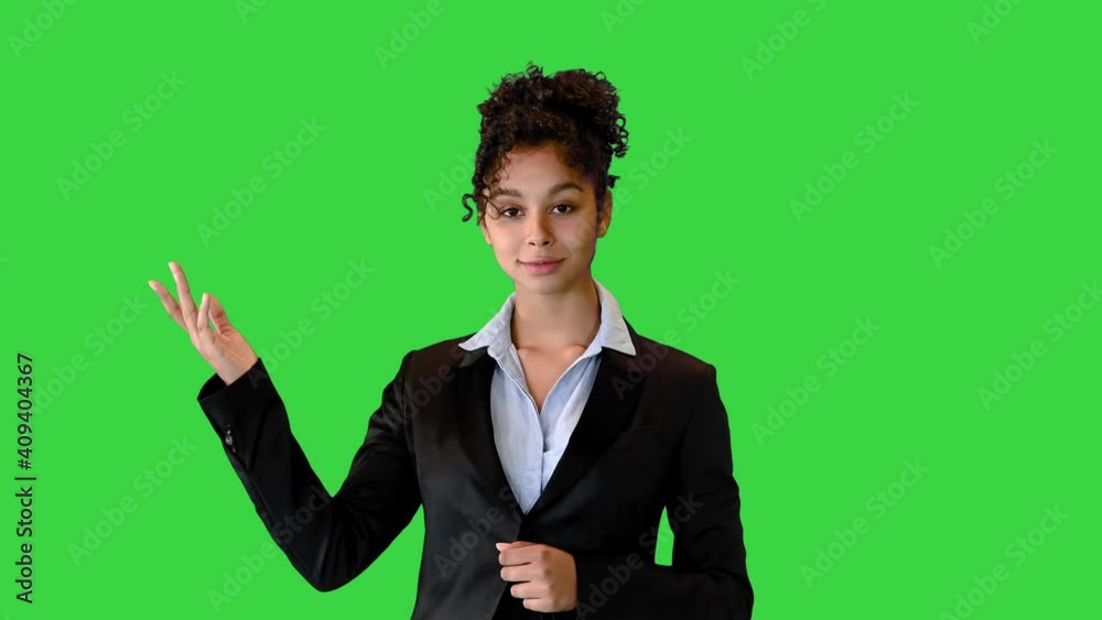 African AMerican businesswoman talking on camera and pointing at a blank space on a Green Screen, Chroma Key. African AMerican businesswoman talking on camera and pointing at a blank space on a Green Screen, Chroma Key.