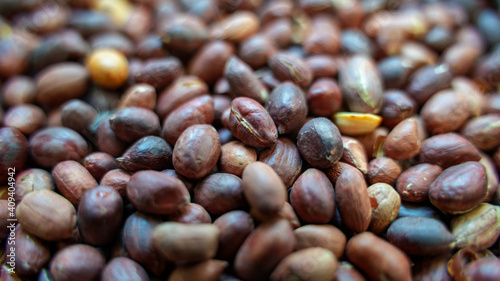 Background image of roasted peanuts with skin 