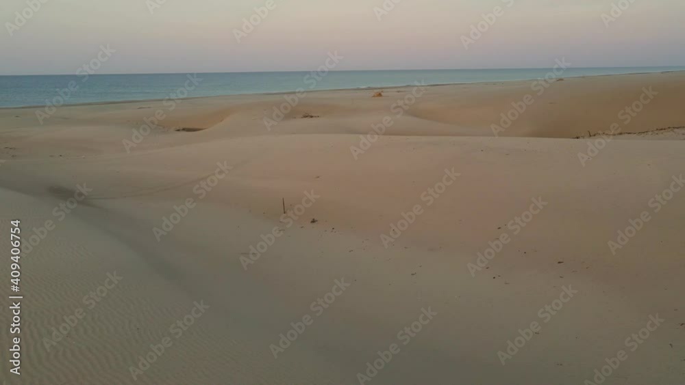 sandy dunes on beach at sunset, sea shore in the evening, tourism, vacations landscape sandy dunes on beach at sunset, sea shore in the evening, tourism, vacations landscape