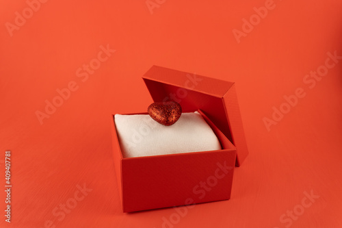 Red gift box with a shiny heart