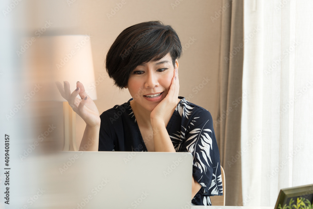 Beautiful and smart looking Asian businesswoman video call with computer laptop from home during Covid 19 pandemic lockdown. New normal in technology at work, teaching, communication, live. Beautiful and smart looking Asian businesswoman video call with computer laptop from home during Covid 19 pandemic lockdown. New normal in technology at work, teaching, communication, live.