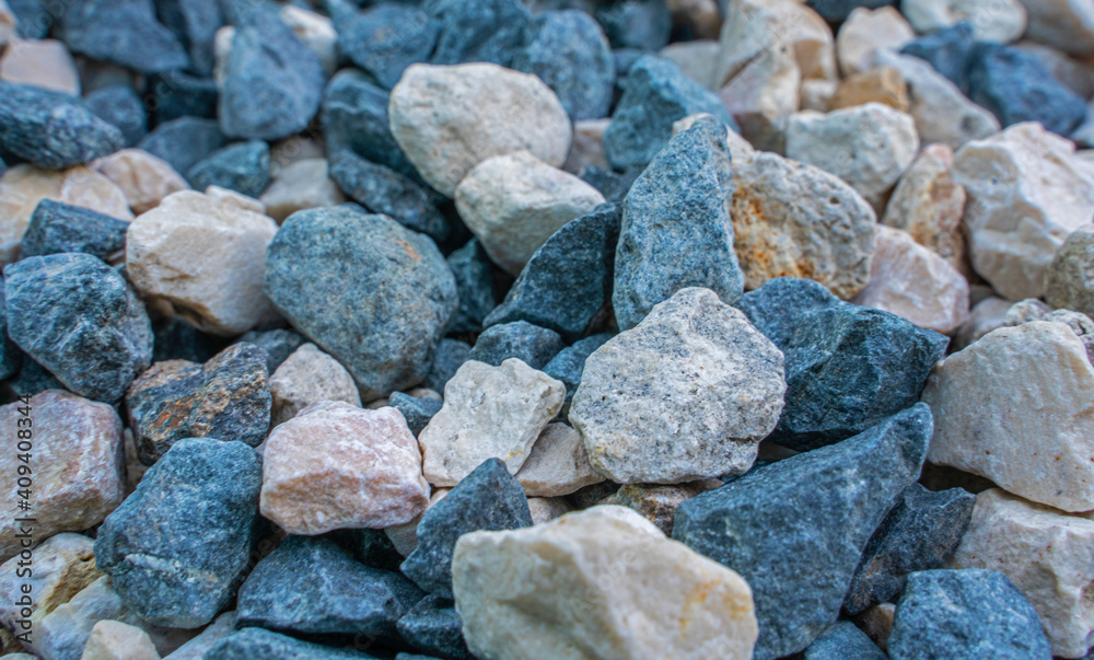 Stone background. blue gravel. Granite texture. The rocky road. Construction material. The texture of the stones. Wallpaper with fine gravel. Stone background. blue gravel. Granite texture. The rocky road. Construction material. The texture of the stones. Wallpaper with fine gravel.