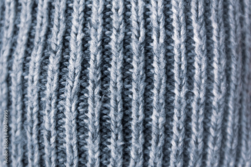 Knitted fabric soft texture close up. Natural grey surface.