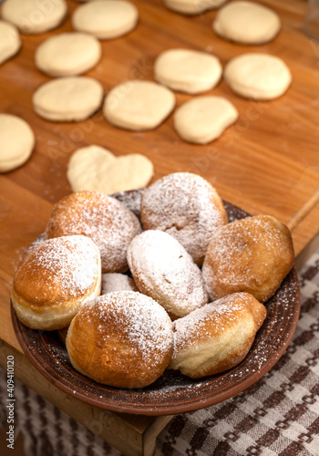 Fried yeast dough donuts on a wooden table