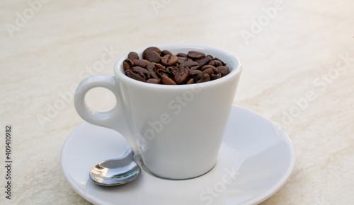 Coffee cup and beans on a white background. Top view with copy space for your text