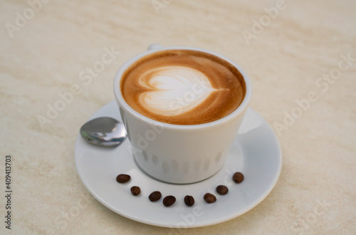Fototapeta Naklejka Na Ścianę i Meble -  Background image of cappuccino in a cup with coffee beans