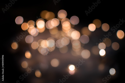gold bokeh of different transparency on a black background