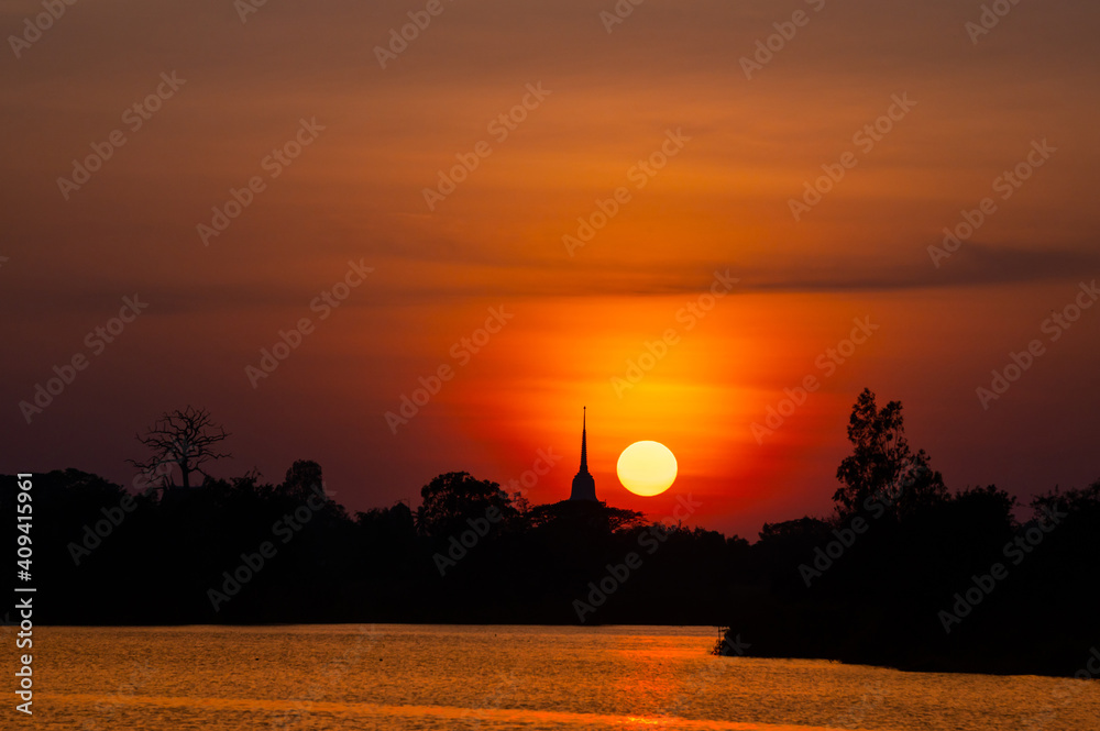 Fototapeta premium Beautiful and vivid Sunset over silhouette Pagoda and river,Thailand,ASIA.