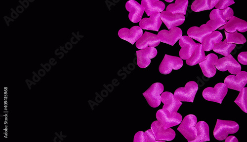  pink volumetric hearts on a black background. scattering of small hearts. High quality photo