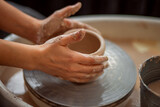 A woman makes a clay product. Close-up of hands