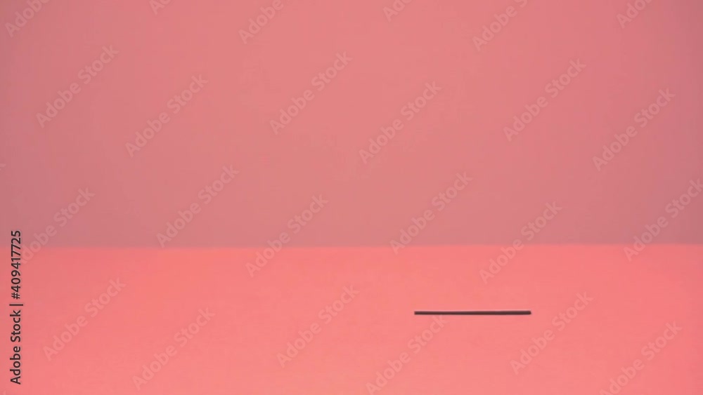 A red heart made of paper is held with tweezers and put in the slot. Valentine's Day, love symbol.