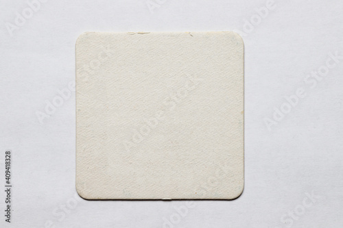Old used coaster or bottle pad. For beer or other drinks, isolated. Add your own design, message or logo.
 photo