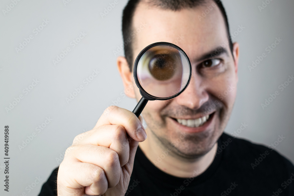 The main subject is out of focus, man hold magnifying glass closeup The main subject is out of focus, man hold magnifying glass closeup