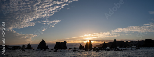 Panormic view of silhouette of Hashigui-iwa Rocks at dawn in Kushimoto City, Wakayama Prefecture, Japan