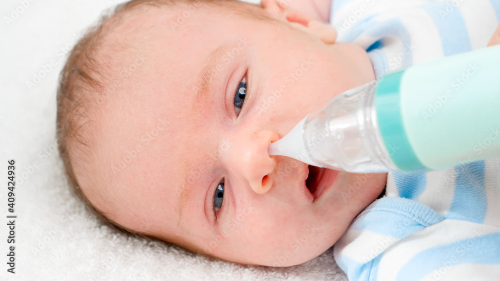 Closeup slow motion of cleaning tiny nose of newborn baby with electric aspirator. Concept of babies and newborn hygiene and healthcare. Caring parents with little children. Closeup slow motion of cleaning tiny nose of newborn baby with electric aspirator. Concept of babies and newborn hygiene and healthcare. Caring parents with little children.