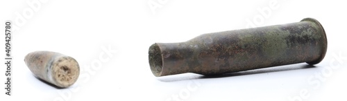 Old Soviet cartridge from the Mosin rifle. Case and bullet on a white background. Patina cartridge. Old ammunition. photo