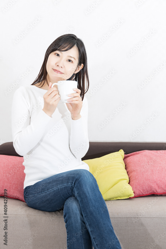 Woman drinking coffee on the couch Woman drinking coffee on the couch
