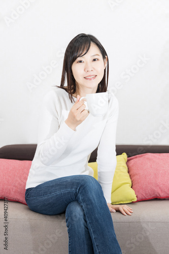 Woman drinking coffee on the couch