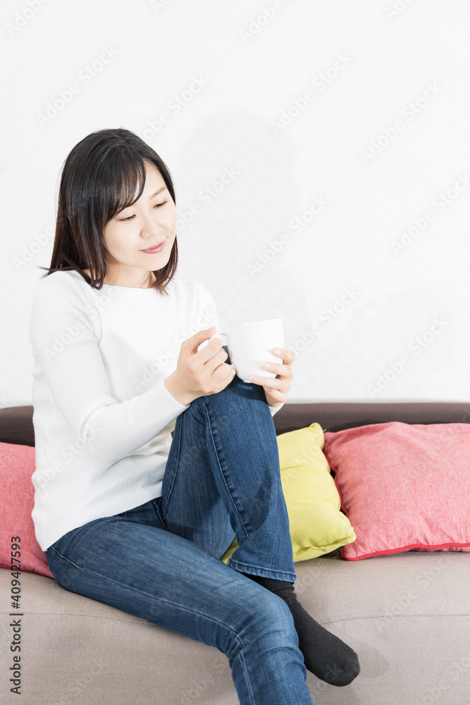 Woman drinking coffee on the couch Woman drinking coffee on the couch