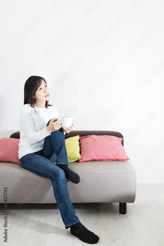 Woman drinking coffee on the couch Woman drinking coffee on the couch