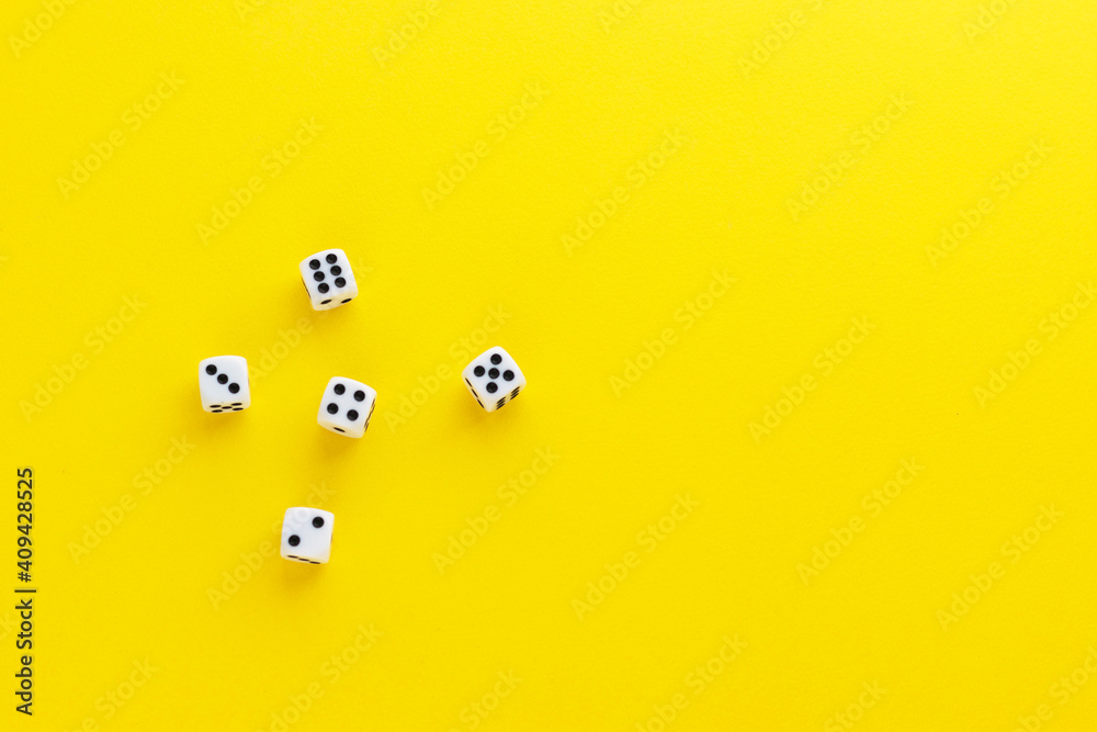 Five dice showing different sides on yellow background. Playing cube with numbers. Items for board games. Flat lay, top view with copy space. Five dice showing different sides on yellow background. Playing cube with numbers. Items for board games. Flat lay, top view with copy space.