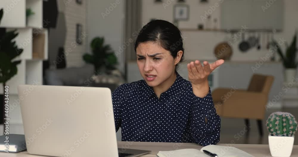 Confused nervous millennial mixed race indian woman looking at computer screen, feeling stressed of reading notification with bad news, getting bank loan rejection or dismissal notice by email.