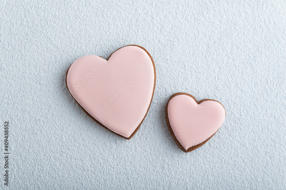 Large and small heart-shaped cookies with icing sugar, white background. Mothers day. Womans day. Valentines day Large and small heart-shaped cookies with icing sugar, white background. Mothers day. Womans day. Valentines day