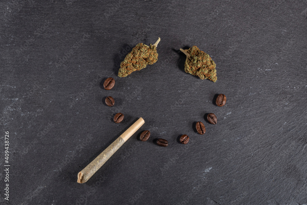 Coffee smile of cannabis with joint - stoned face made of weed and coffee beans Coffee smile of cannabis with joint - stoned face made of weed and coffee beans