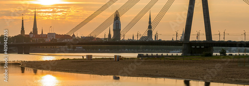 View on cable bridge and historical district of o Riga - the capital of Latvia and famous Baltic city widely known among tourists due to its unique medieval and Gothic architecture