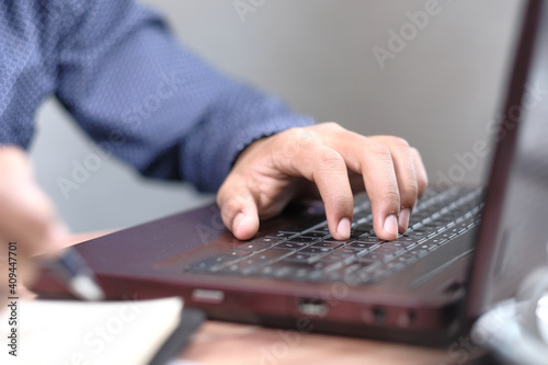 Close up of man hand typing on laptop.