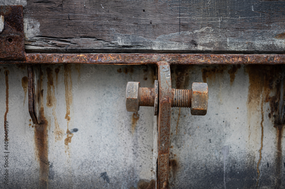 detail of a rusty screw of a metal structure. The screw is loose detail of a rusty screw of a metal structure. The screw is loose