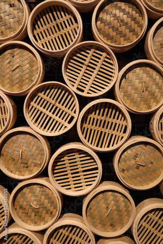 Top view of Textured wall with bamboo wood circular steam baskets, Asian culinary theme background photo