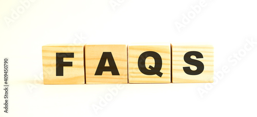 The word FAQS. Wooden cubes with letters isolated on white background.