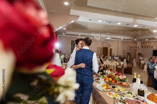 the bride and groom kiss in a restaurant  the happiness of the newlyweds at the wedding ceremony  a romantic kiss