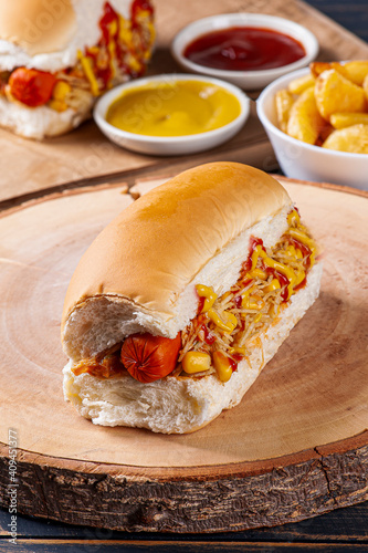 .Brazilian style hot dog, with mustard, ketchup and potato straw