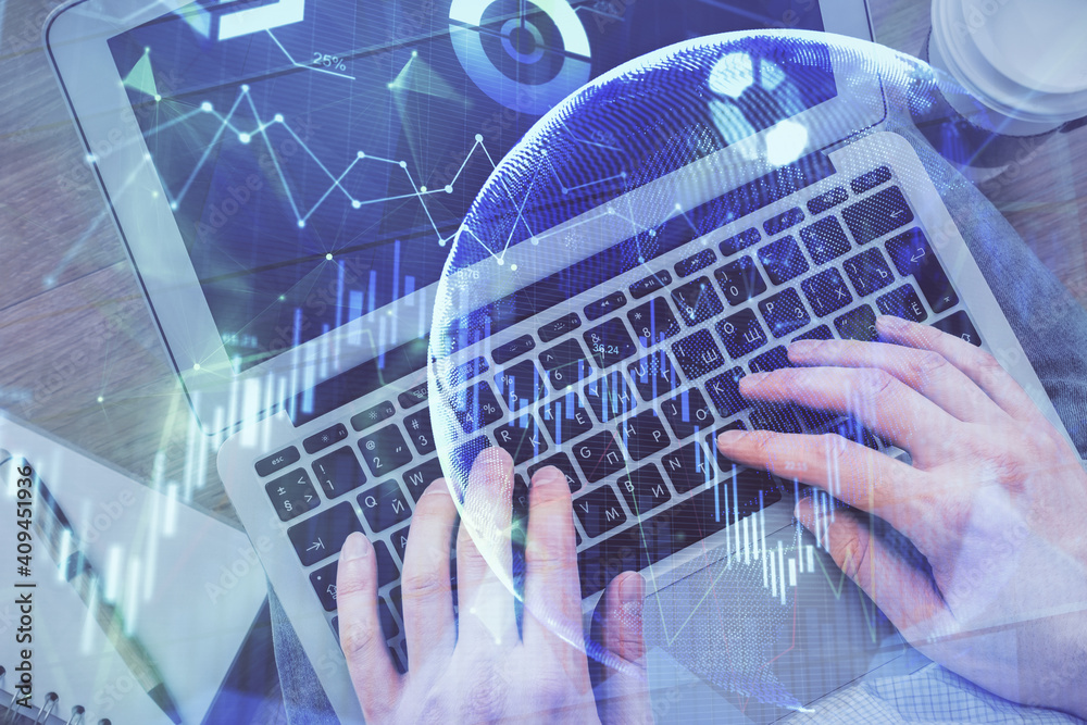 Double exposure of man's hands typing over computer keyboard and forex graph hologram drawing. Top view. Financial markets concept. Double exposure of man's hands typing over computer keyboard and forex graph hologram drawing. Top view. Financial markets concept.