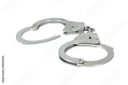 Handcuffs with one open isolated on white background without shadows. Pair of silver handcuffs macro close-up high resolution.